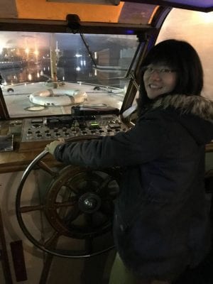 Lingfeng Ge driving a boat