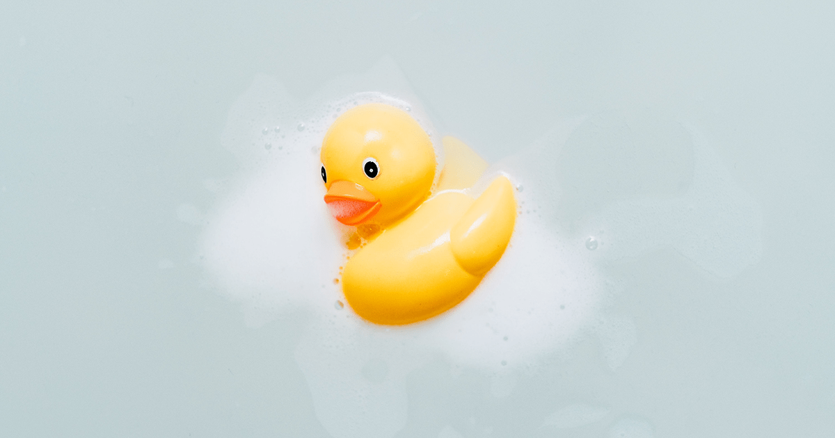 A rubber duck floating in bathwater