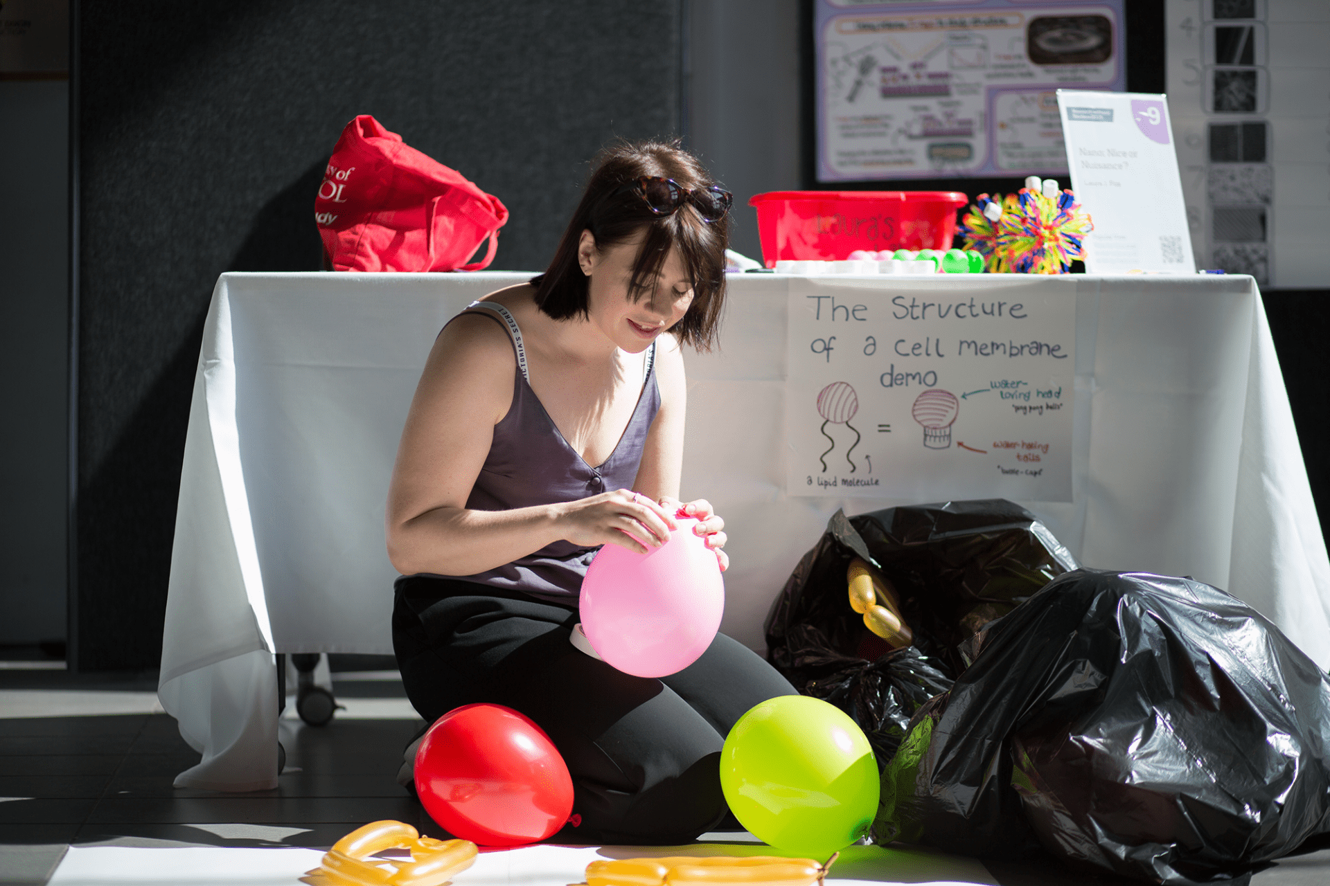 Laura Fox tying up an inflated balloon