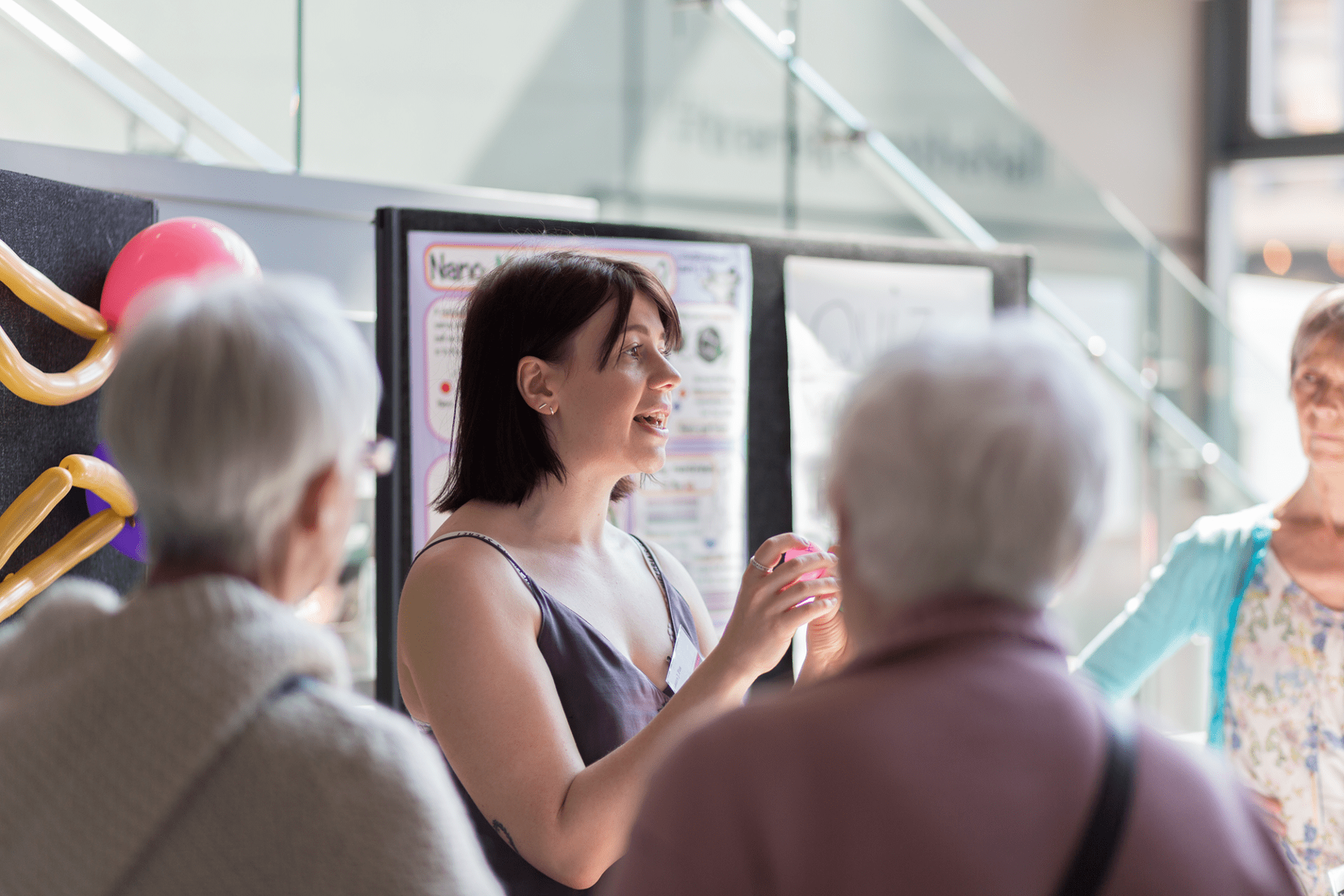 Laura Fox talking to a group at the Research without Borders 2019 exhibition
